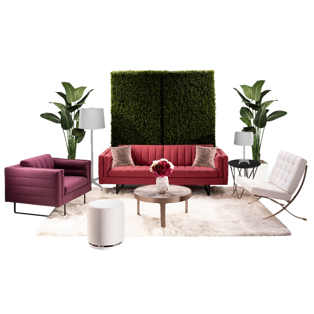 green soft seating set up with life like trees and orange accents