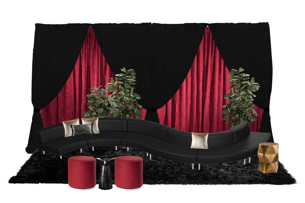 green soft seating set up with life like trees and orange accents