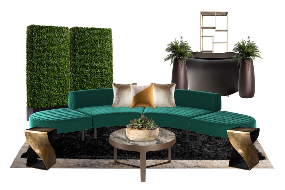 green soft seating set up with life like trees and orange accents
