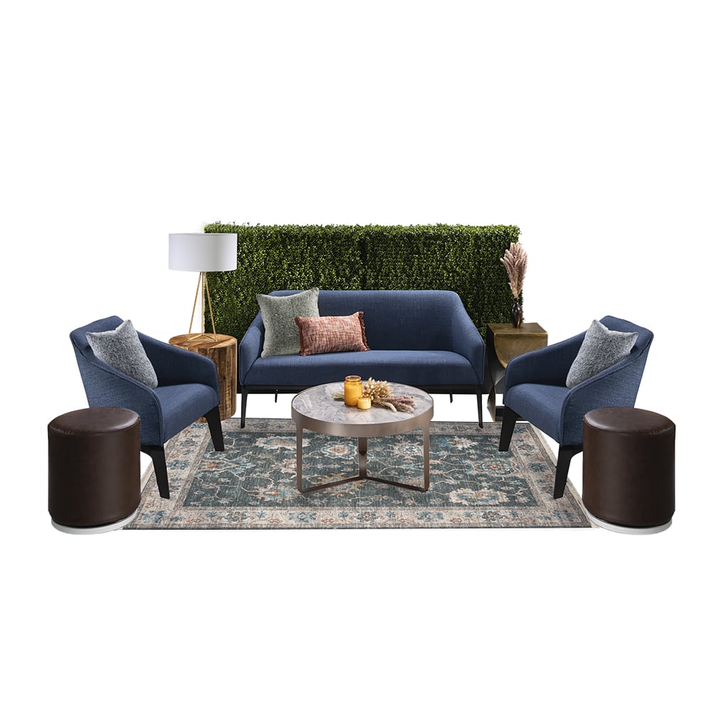 green soft seating set up with life like trees and orange accents