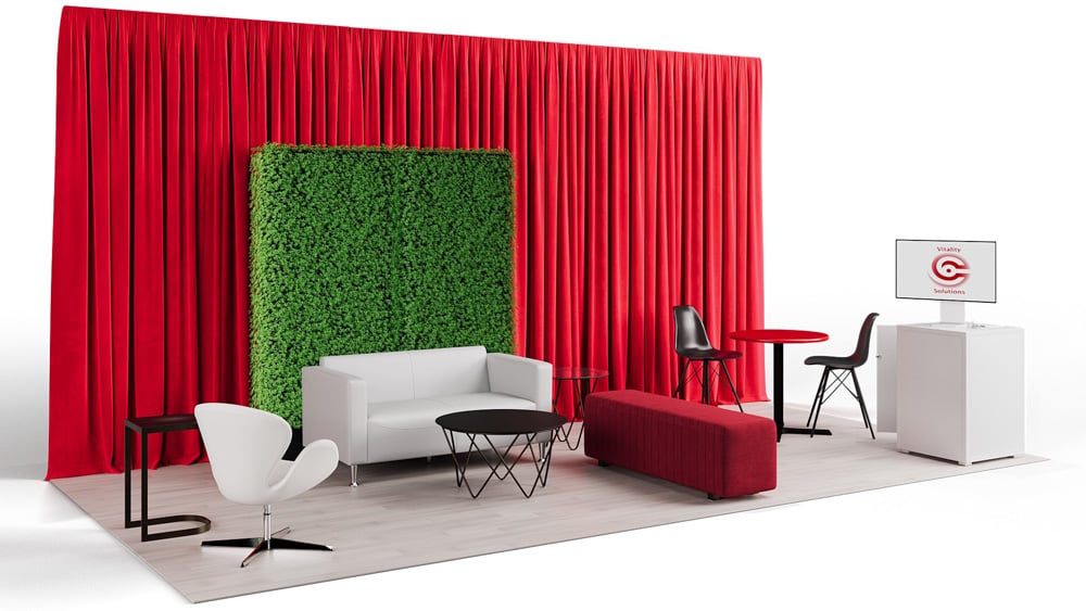 green soft seating set up with life like trees and orange accents