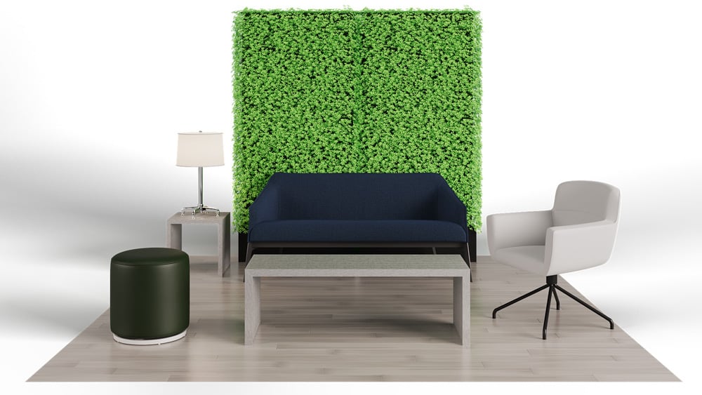 green soft seating set up with life like trees and orange accents