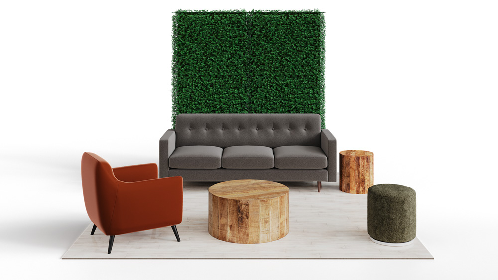 green soft seating set up with life like trees and orange accents