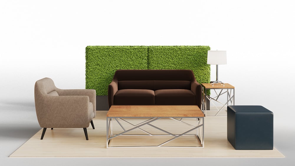 green soft seating set up with life like trees and orange accents
