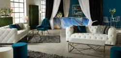 lounge area with white tufted sofas and blue accents