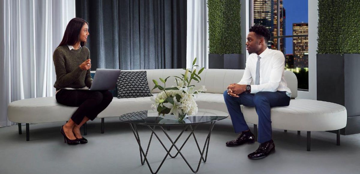 two people sitting on white sofa