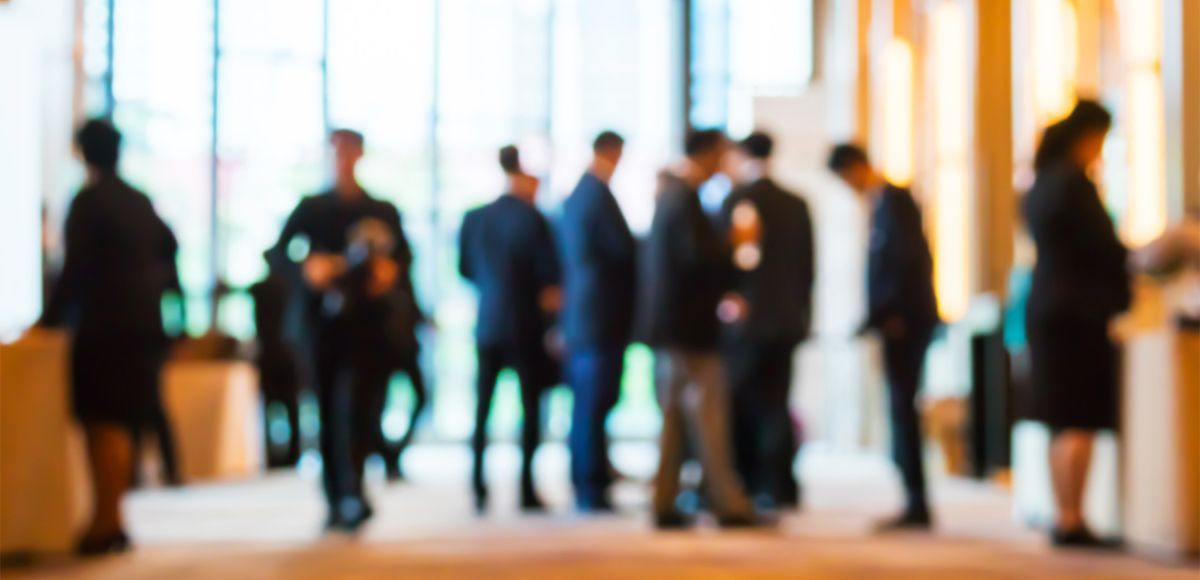 blurred image of corporate people standing scattered