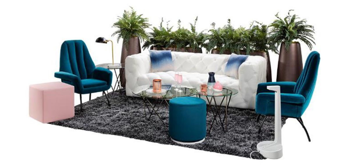 white tufted sofa with teal accent chairs and pink ottoman