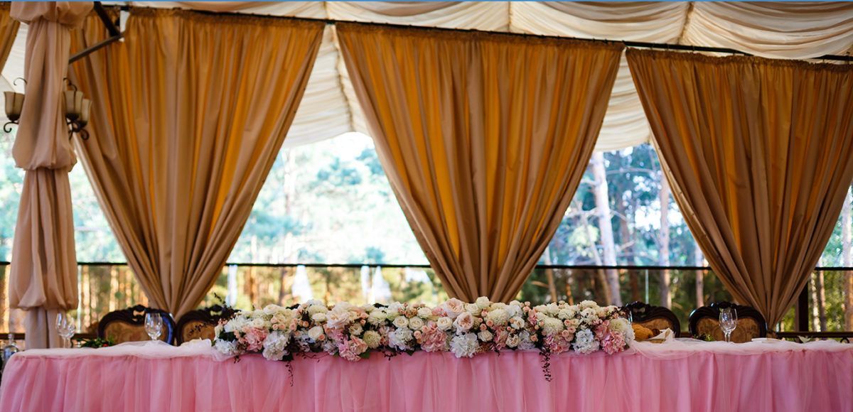 table at wedding reception with drape behind