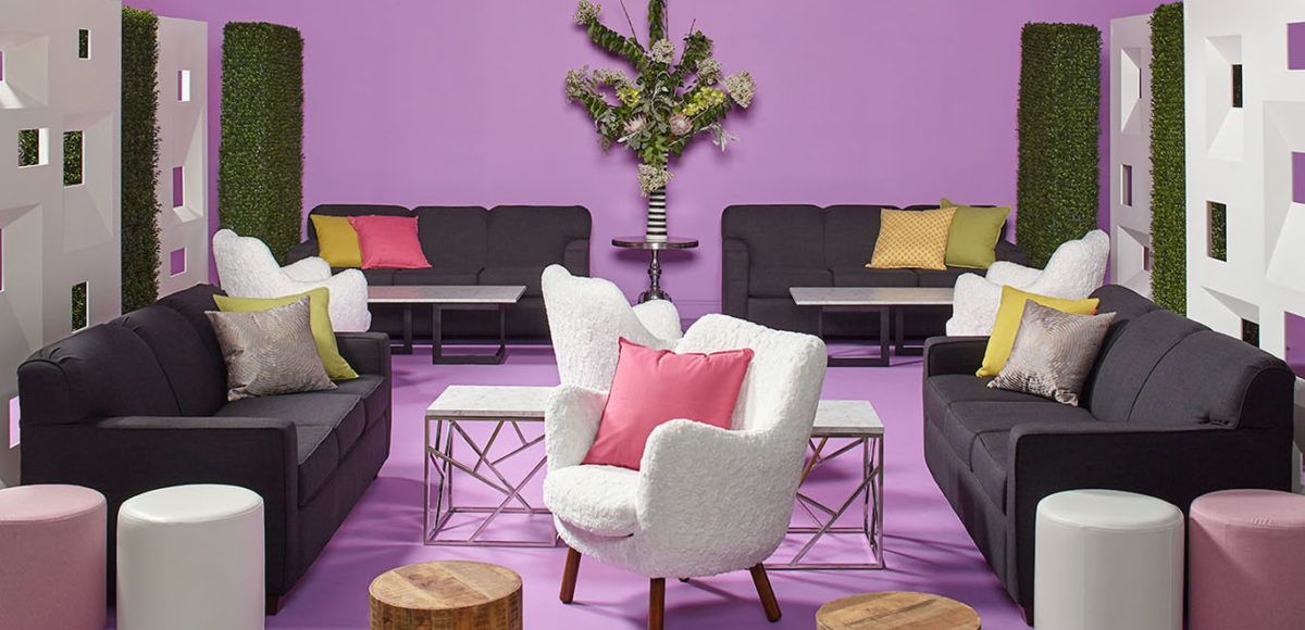lounge with black and white seating and pink and white accents 