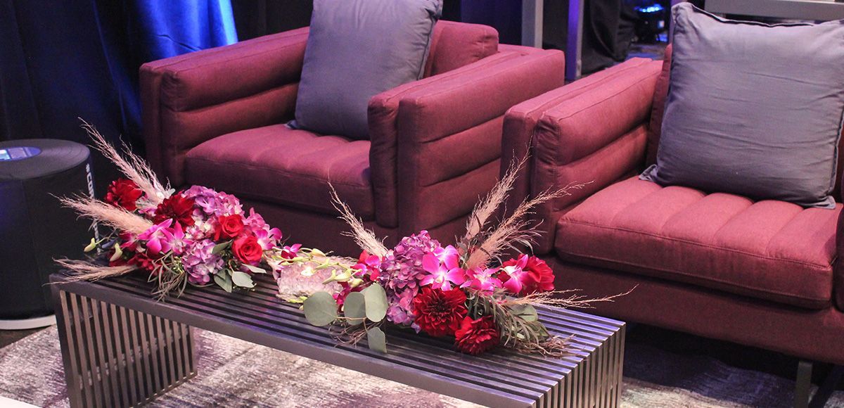 metal table paired with purple tufted chairs