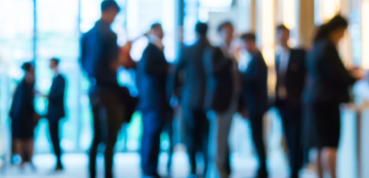 blurred image of corporate people standing scattered