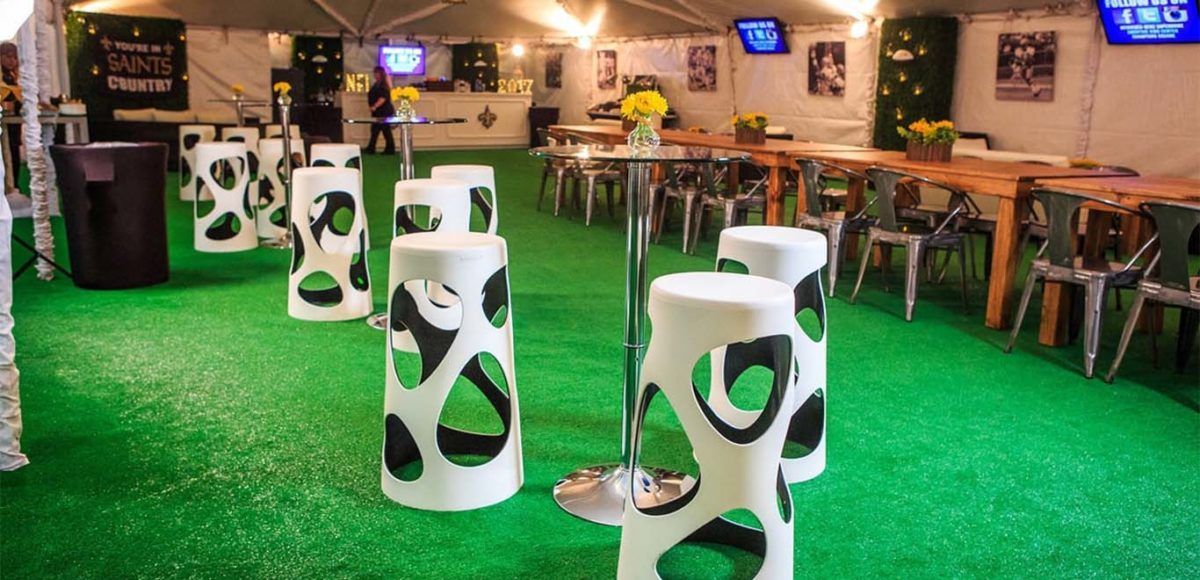 vip tent for football game with white bar stools and bar table