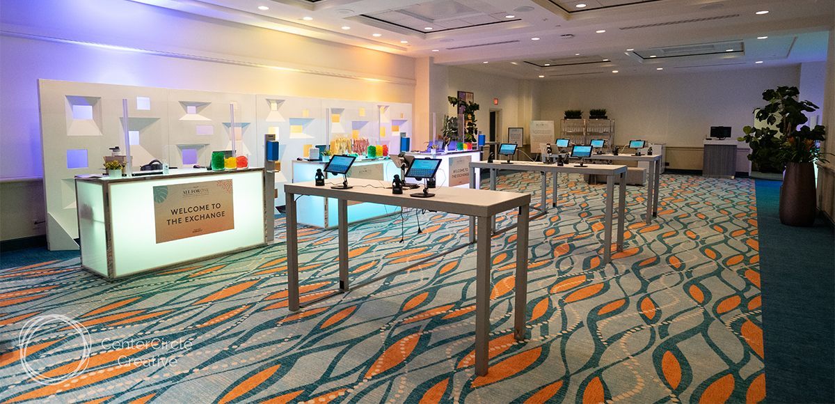 registration area with led-lit bars, white dividers and communal bar tables