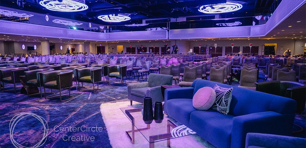 large conference seating area with blue low lighting and various soft seating