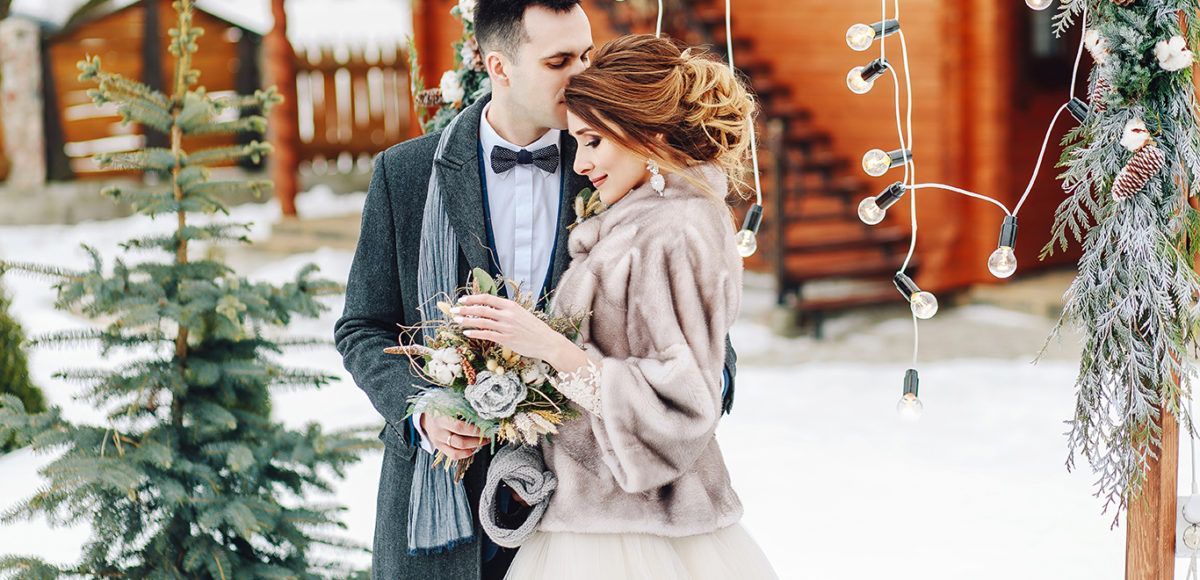 couple outside winter cabin