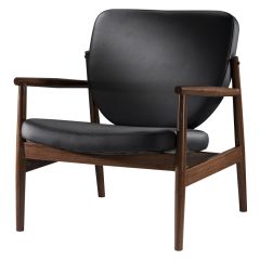 Chic black vinyl accent chair with walnut-metal frame.