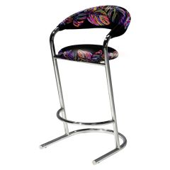 Curved barstool with chrome legs and customizable fabric cover with colorful floral design over back and seat. 