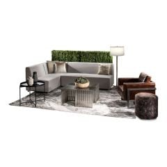 Refined event rental package featuring sand colored soft seating, brown leather club chair, brushed metal end tables, and boxwood hedges. 