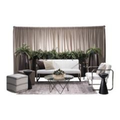 Event rental package featuring white vinyl and chrome soft seating, cube ottomans, glass-top bronze base tables, plastic bronze fern planters, and beige velour drape. 