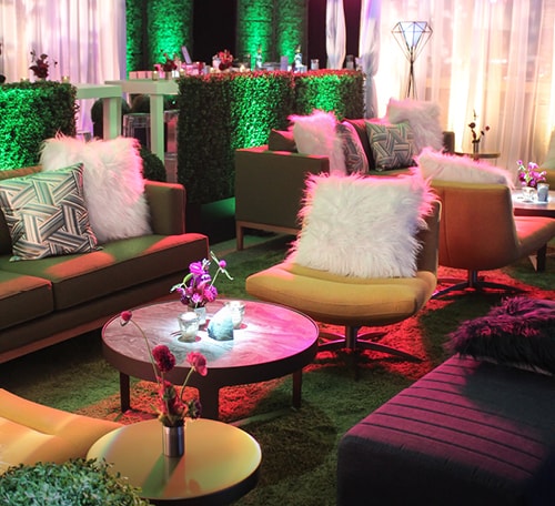 sitting area at party with yellow and green chairs and shag pillows