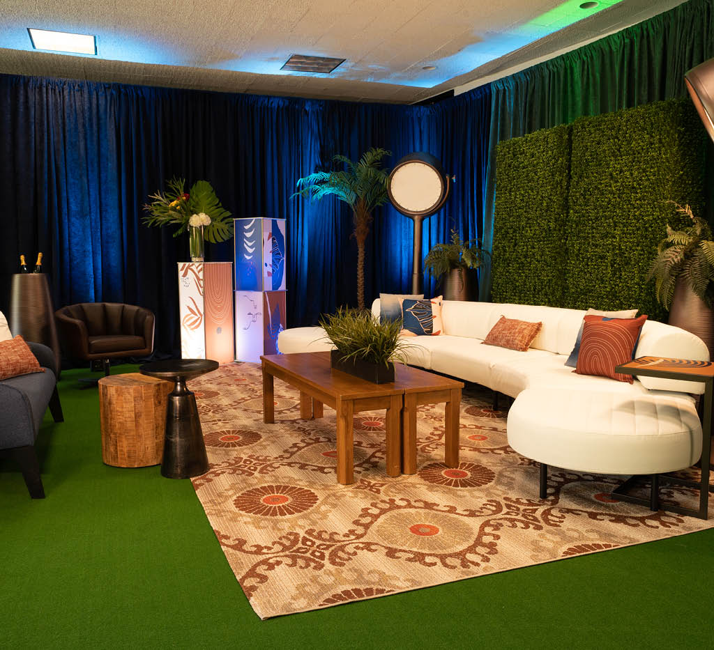 lounge with white sofa, greenery and wood accents