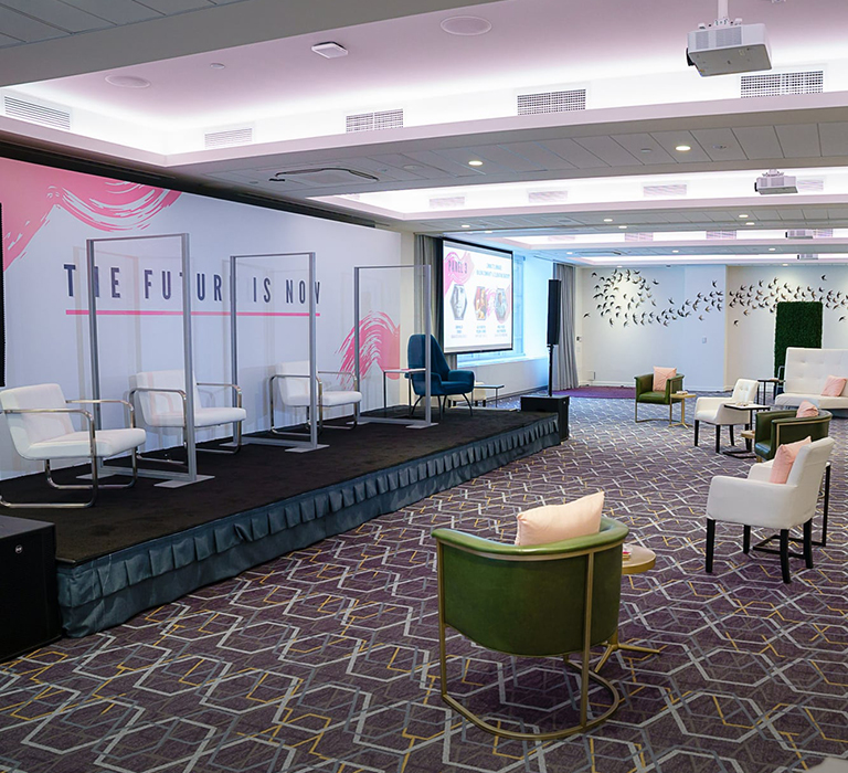 Clear dividers with white chairs on stage