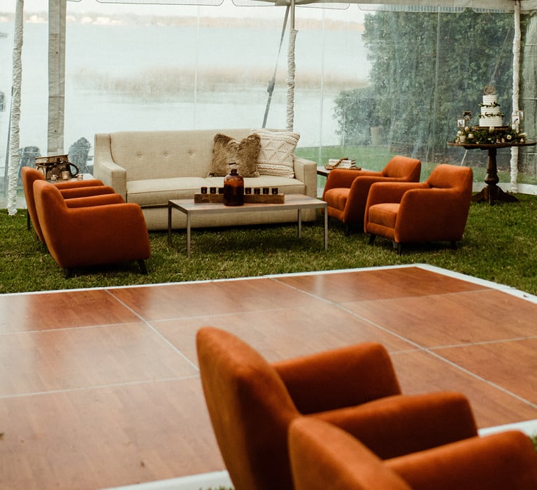 reception in tent with beige and orange furniture