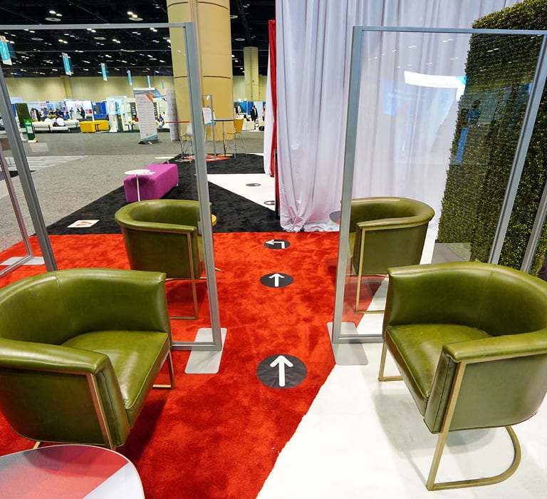 green accent chairs split up by clear dividers