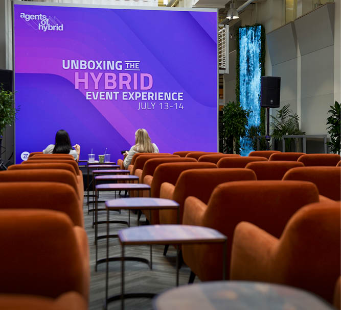 meeting with rows of spice orange club chairs and wood side tables