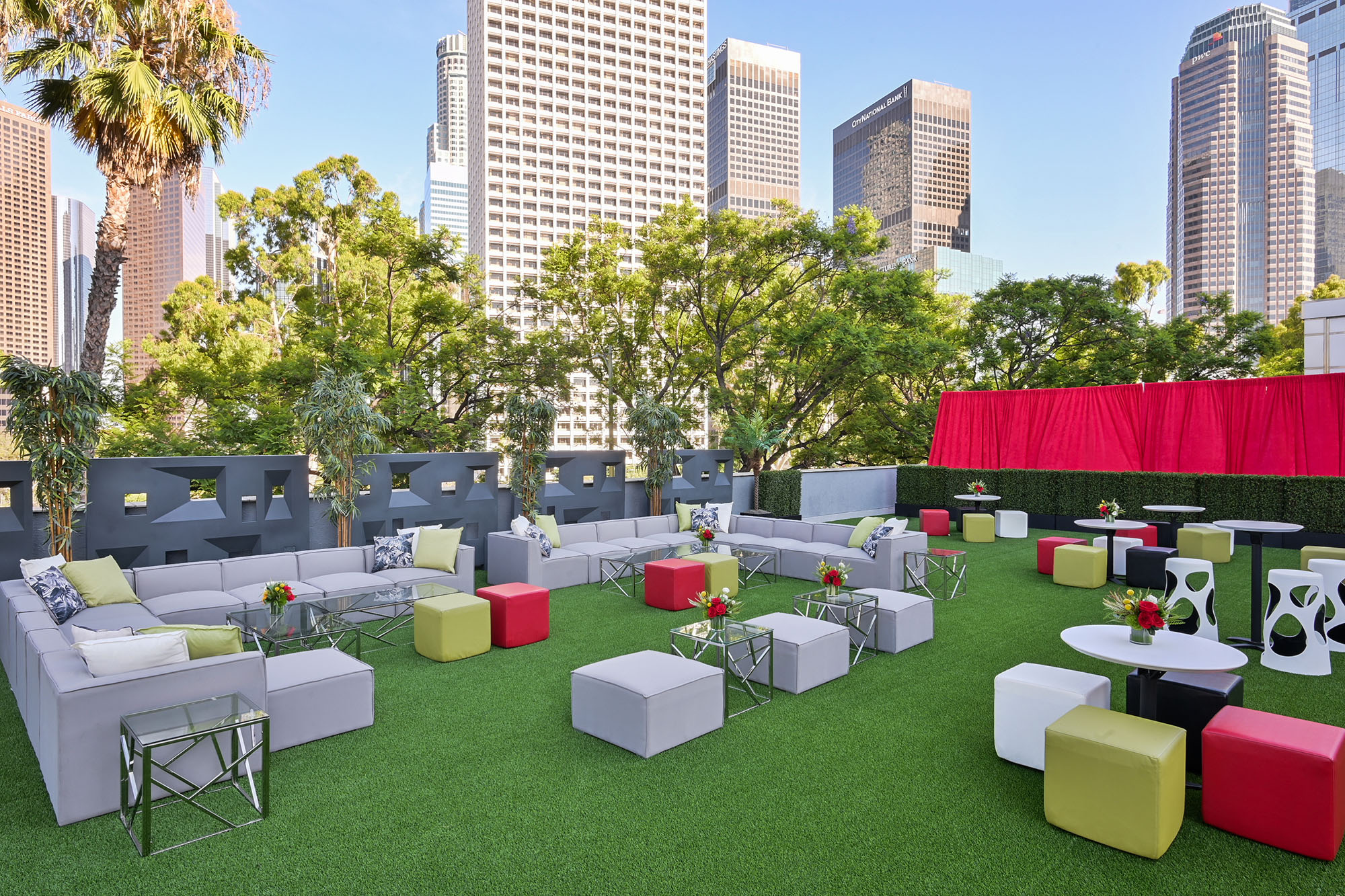 outdoor event with gray soft seating and red and green accents