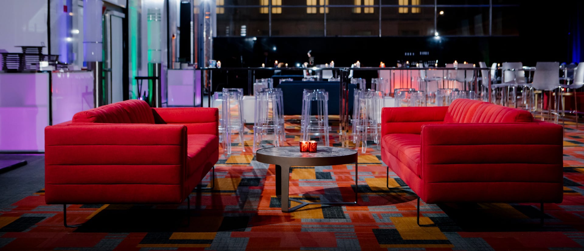 Red club chairs with a gray cocktail table