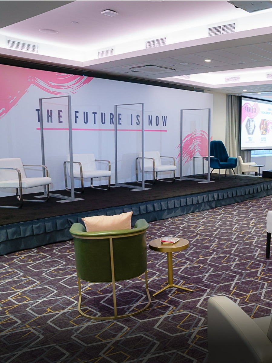Clear dividers with white chairs on stage