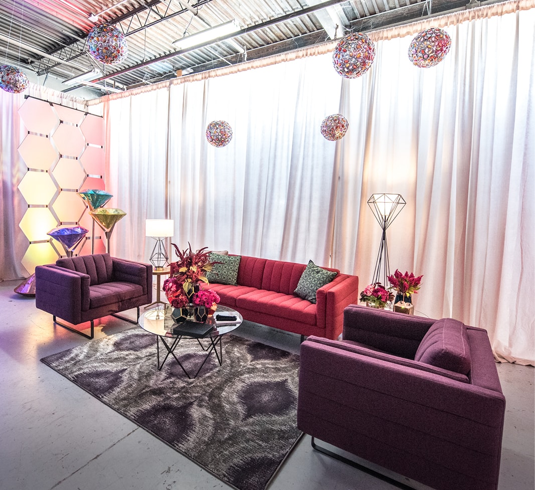 red and purple sofas in event lounge