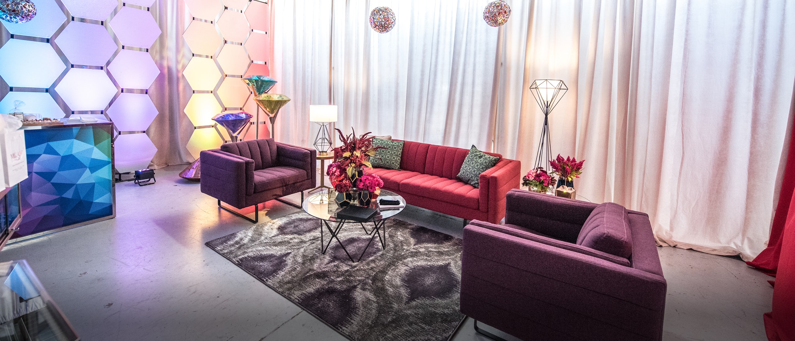 red and purple sofas in event lounge