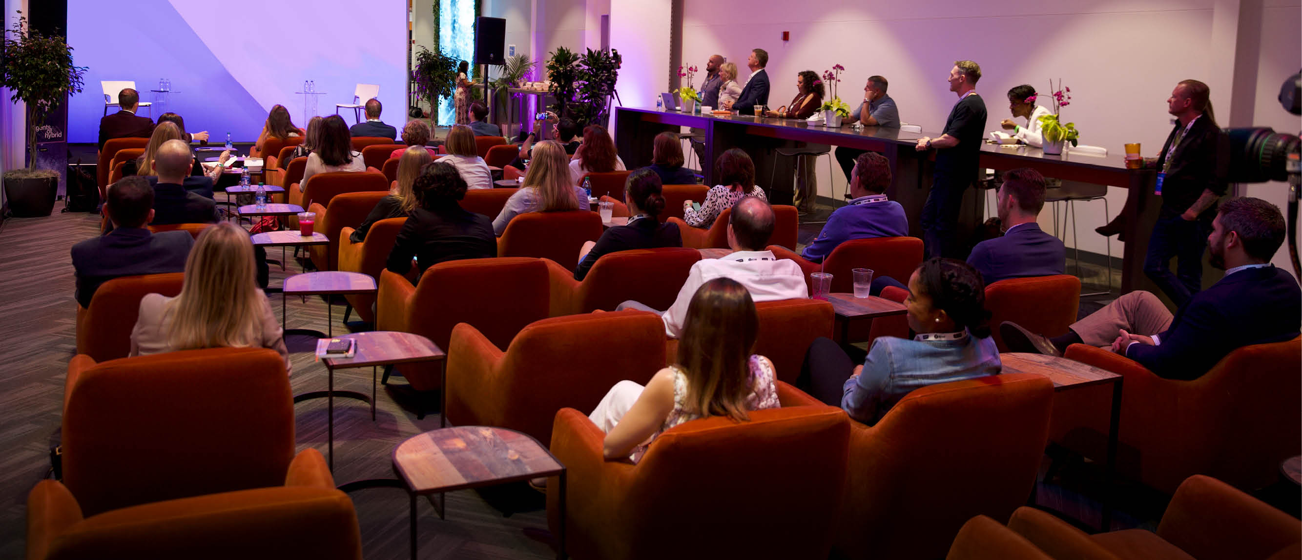 presentation with spice orange club chairs in front of screen