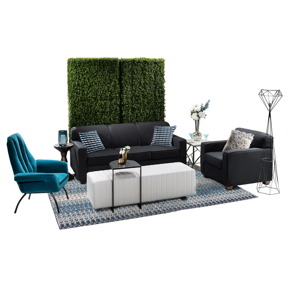 green soft seating set up with life like trees and orange accents