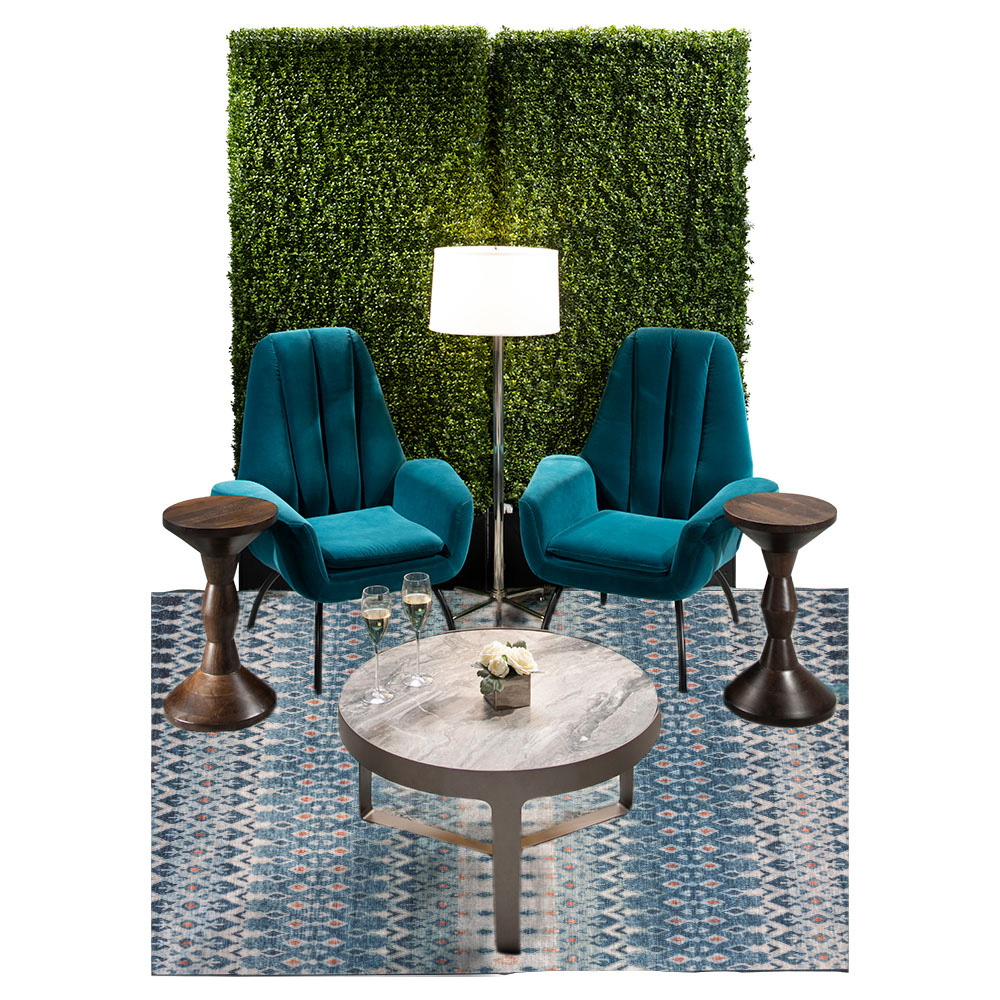 green soft seating set up with life like trees and orange accents