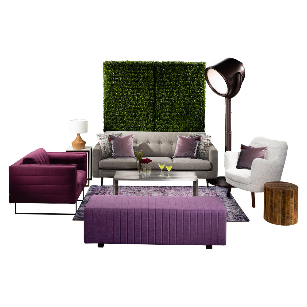 green soft seating set up with life like trees and orange accents